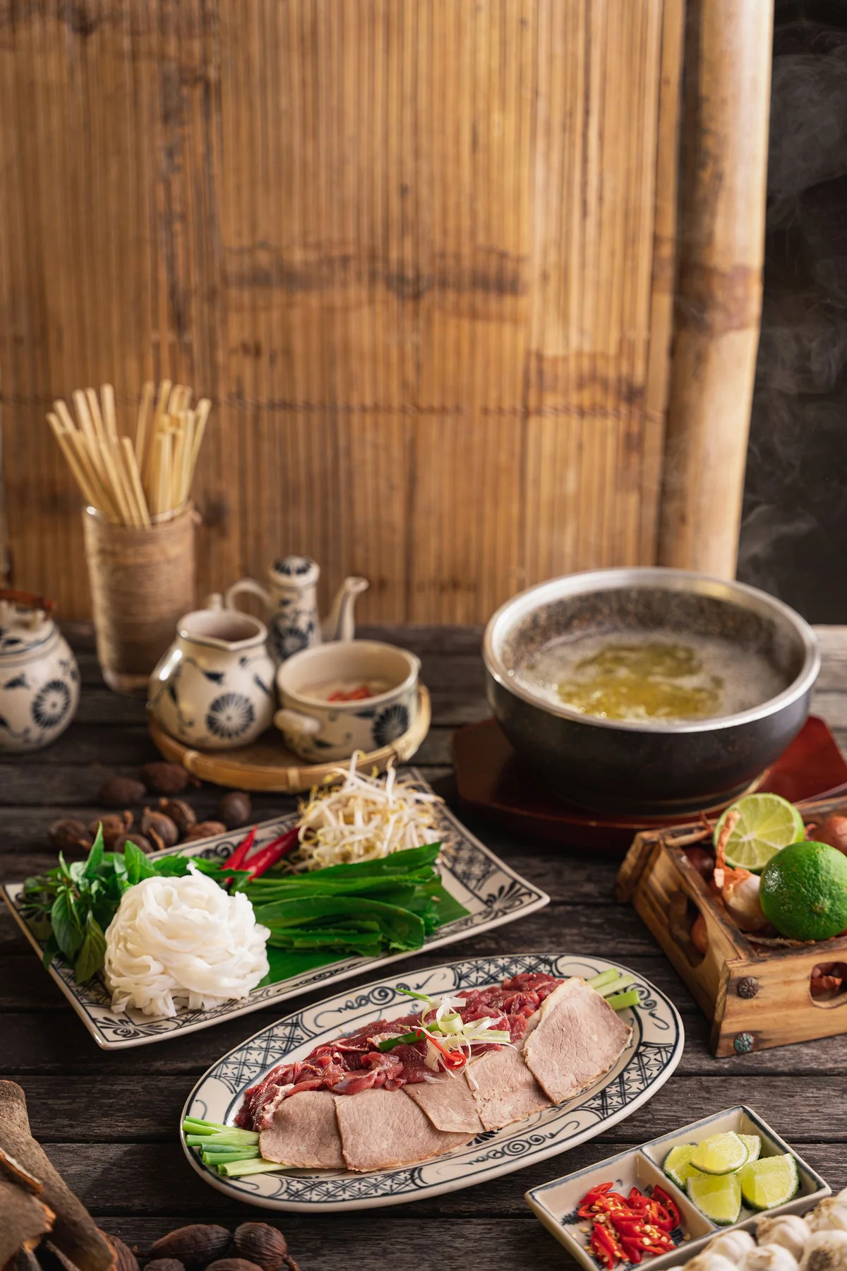 Chinese hot pot with broth, vegetables, herbs and ingredients for shared cooking