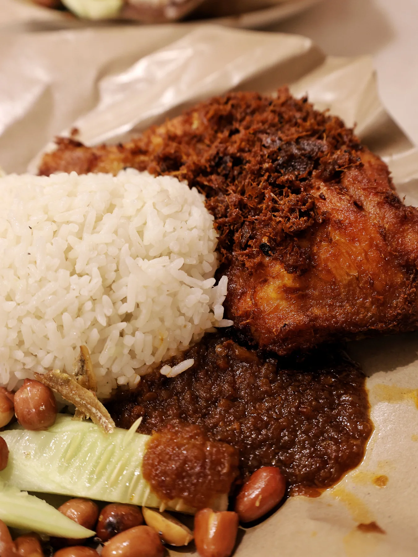 Nasi lemak with coconut rice, sambal, peanuts, egg and crisp chicken