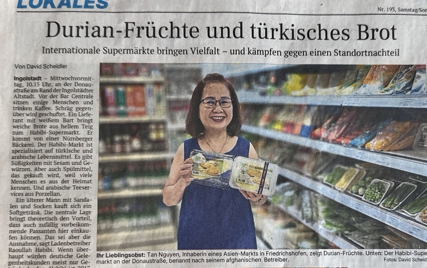 Local newspaper feature about international supermarkets in Ingolstadt showing Tan Nguyen inside an Asian grocery store