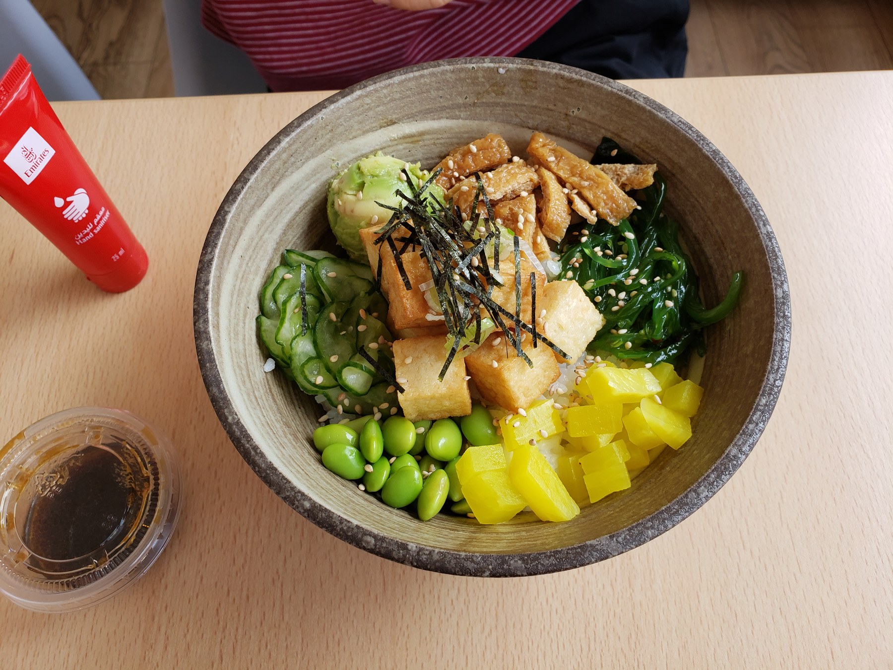 Vegan poke bowl with fried tofu and colourful vegetables