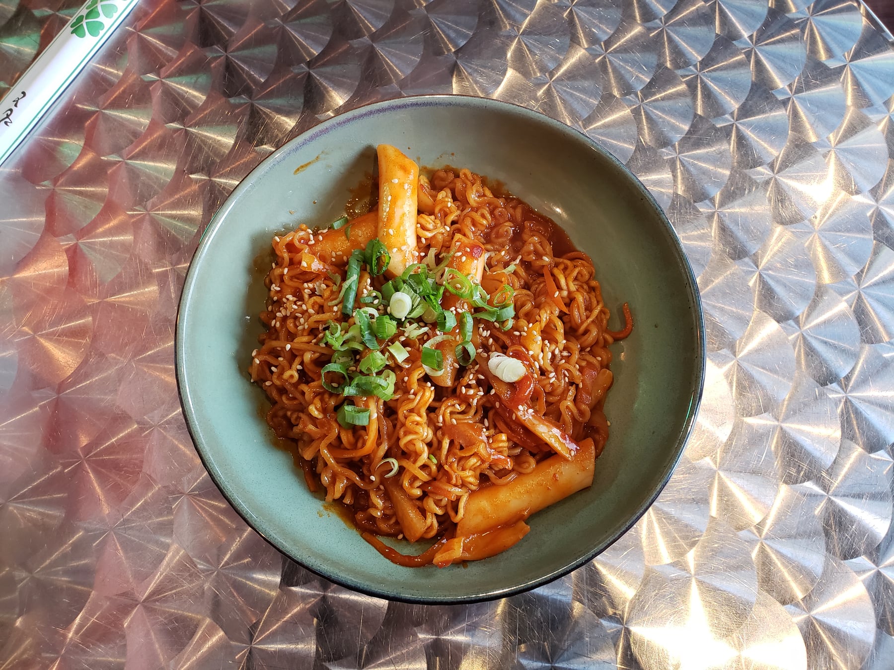 Korean rabokki with ramen noodles and rice cakes in red sauce.